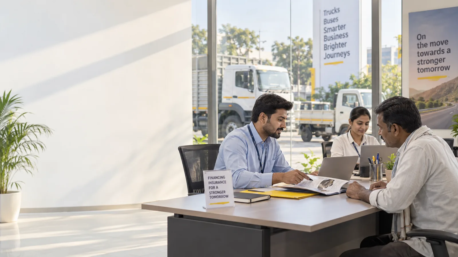 A finance partner's team talks a transporter through a scheme at a desk; trucks and a pickup stand in the yard behind the glass.